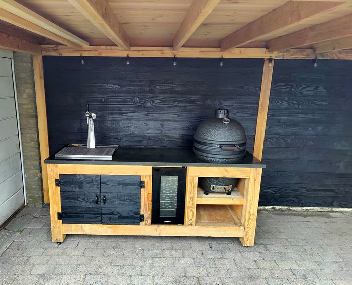 Douglas buitenkeuken met tap, wijnkoeler en kamado voor een zwarte wand