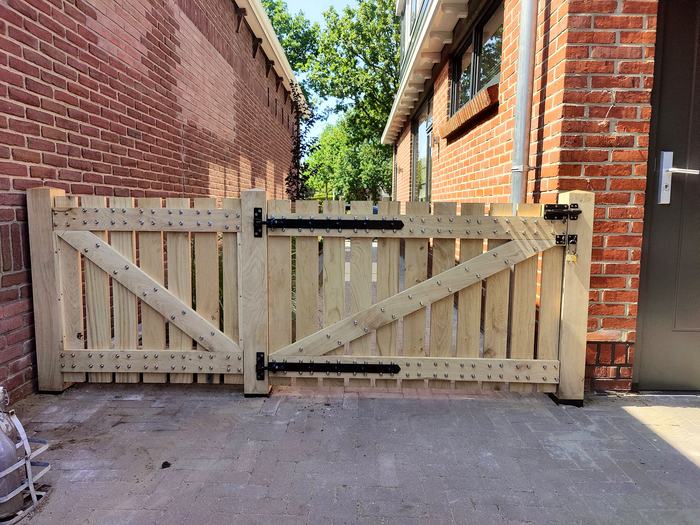 Dubbele houten poort met sierbouten